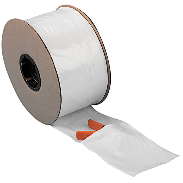 A roll of white plastic pre-opened bags with a black circular object with a hole.