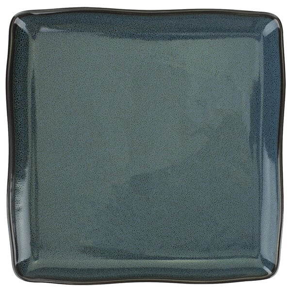 A square midnight blue porcelain plate with a speckled surface.