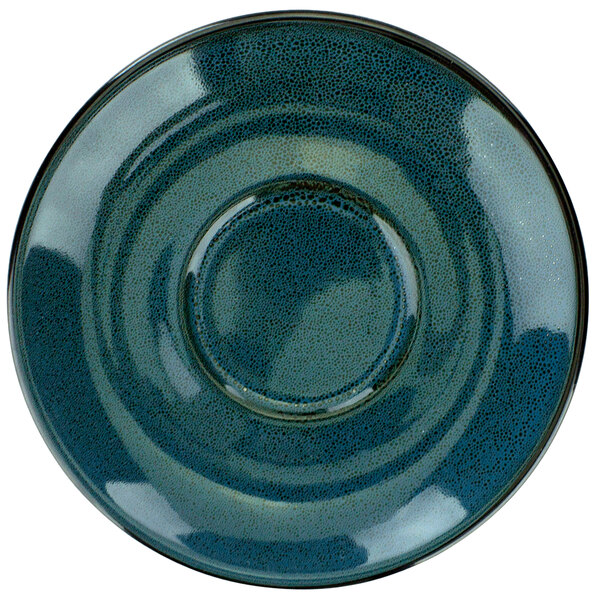 A close-up of a International Tableware Luna midnight blue porcelain saucer with a small rim and a blue circle.