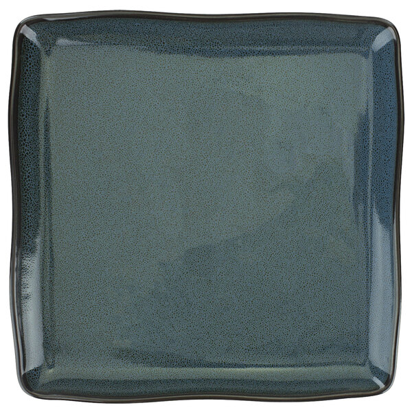 A white square porcelain plate with a speckled midnight blue surface.