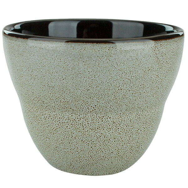 A white porcelain bowl with brown speckles.
