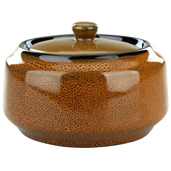 A terracotta porcelain bowl with a black lid.