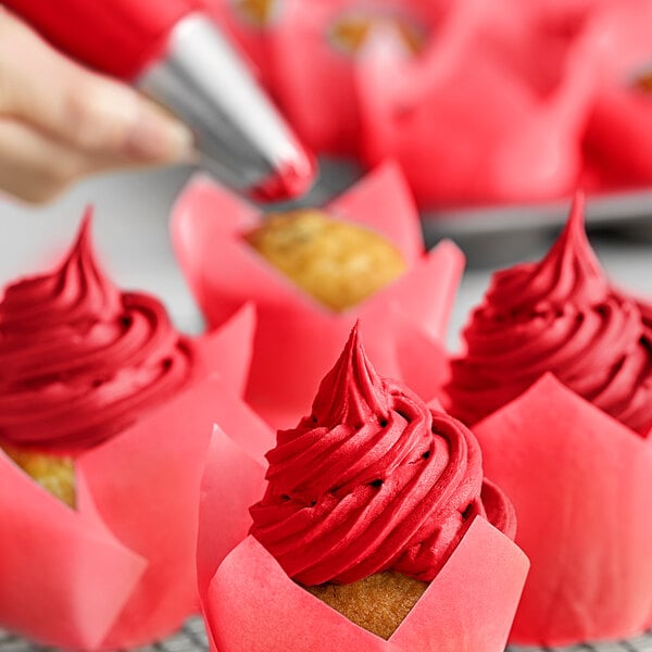 A close-up of a Christmas red cupcake with Chefmaster Christmas Red Liqua-Gel frosting.