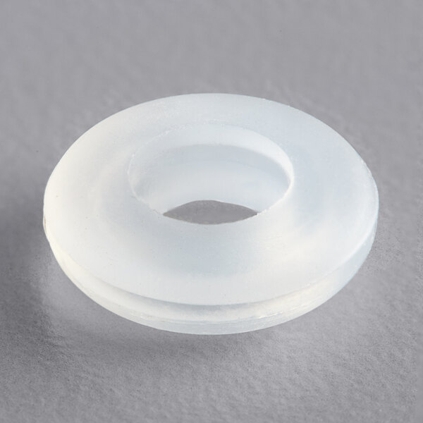 A white round plastic grommet with a hole in it.