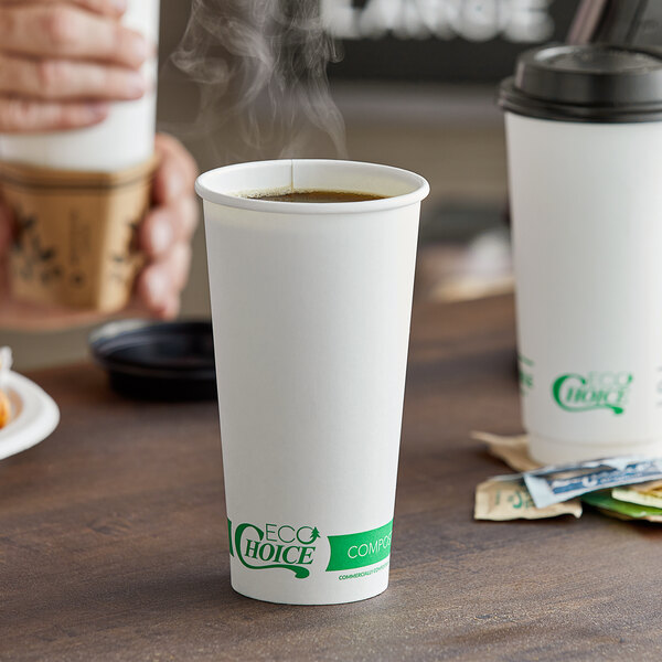 A hand holding a white EcoChoice paper hot cup of coffee.