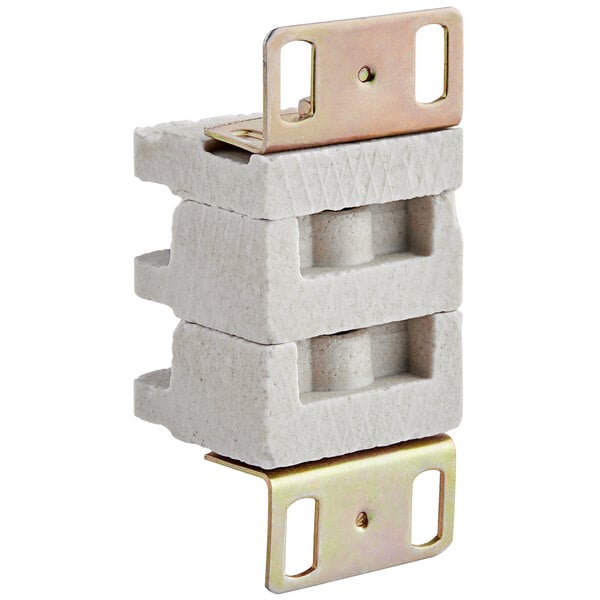 A close-up of a white terminal block with metal brackets.