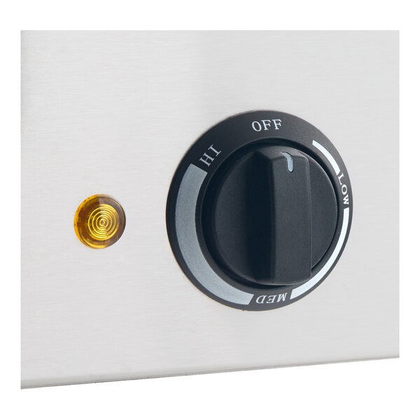 A close-up view of a control knob with settings labeled OFF, LOW, MED, and HI, next to a small amber indicator light on a metallic surface.