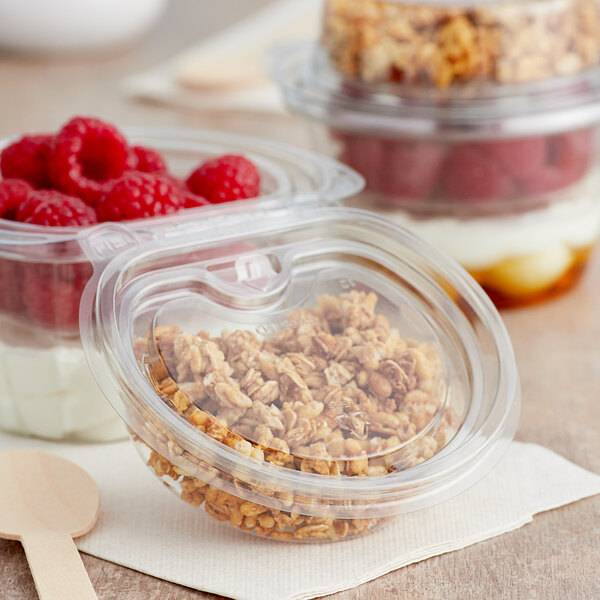 A Clear PET parfait cup with yogurt and granola in it.