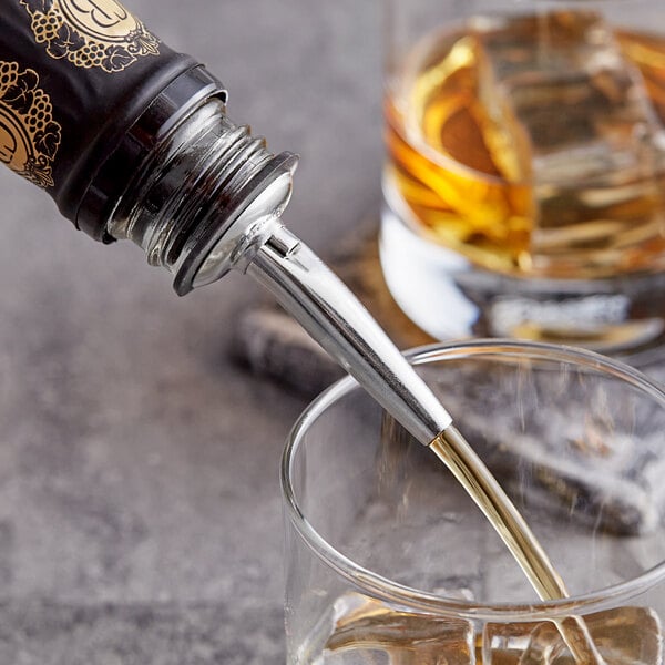 A Barfly stainless steel liquor pourer pouring alcohol into a glass.