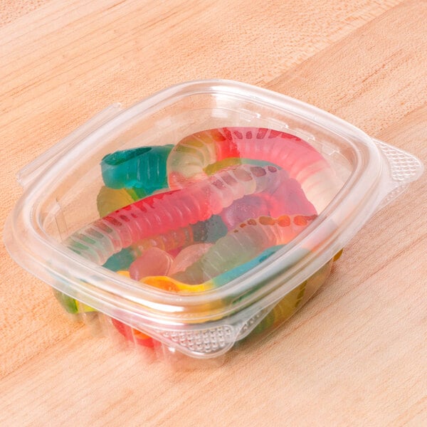 A clear Genpak plastic deli container filled with colorful gummy candies.
