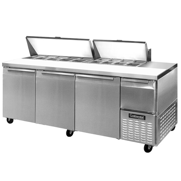 A Continental Refrigerator stainless steel food prep table with three doors.