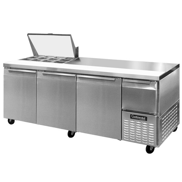 A stainless steel Continental Refrigerator with three doors open over a counter.