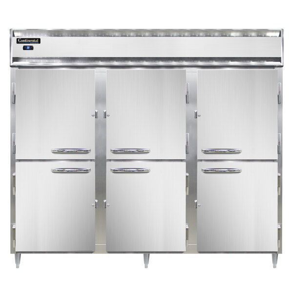A white cabinet with three Continental Refrigerator stainless steel reach-in refrigerators with open doors.