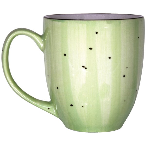 A lime green porcelain mug with black dots.