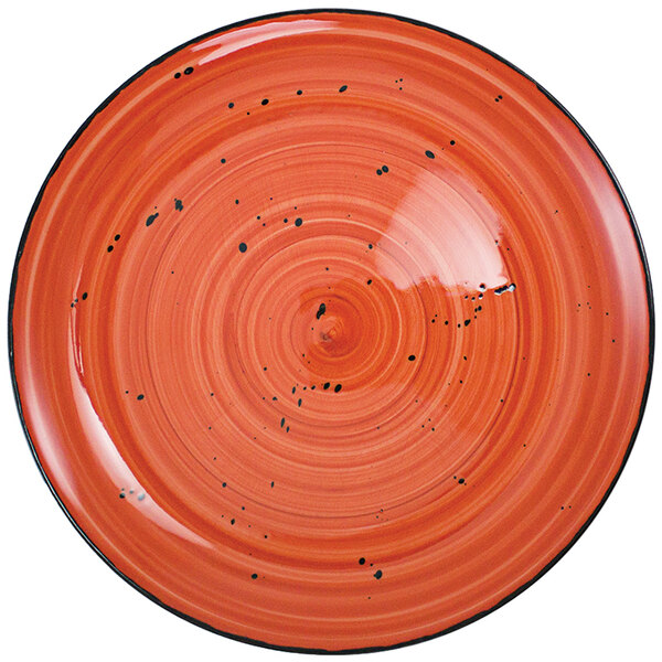 A red porcelain plate with black specks.