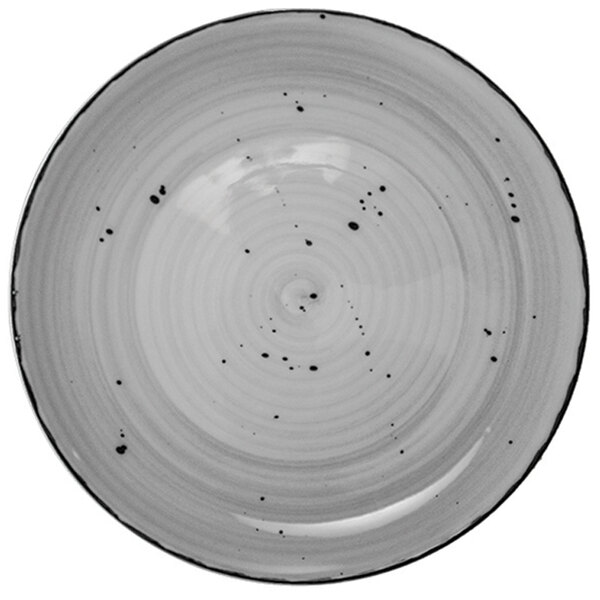 A close-up of a white International Tableware pasta bowl with black specks.