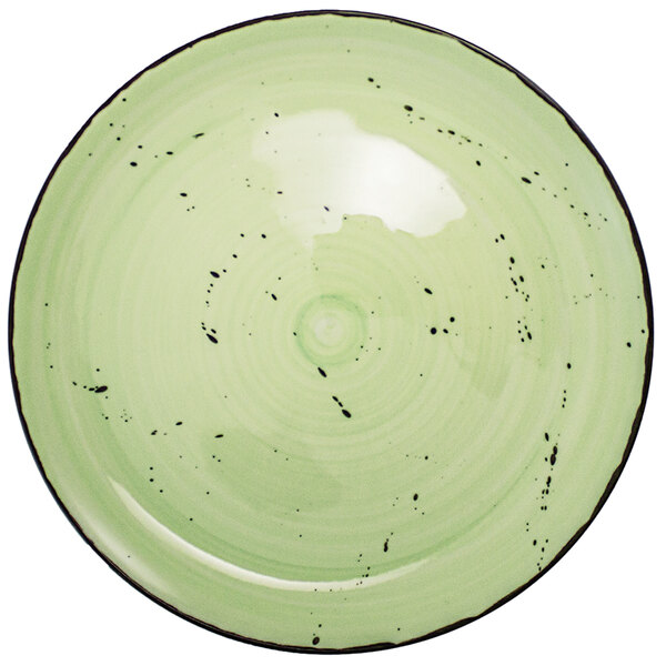 An International Tableware lime green porcelain plate with black specks.