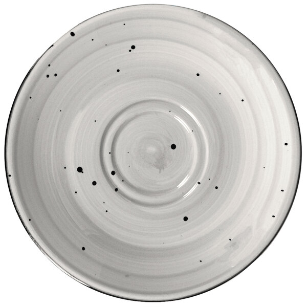 A white International Tableware Rotana porcelain saucer with black dots.