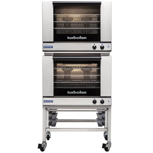 A Moffat Turbofan double deck electric convection oven with shelves on wheels.