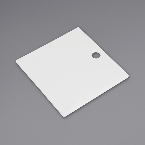 A white square filler plate with a hole.
