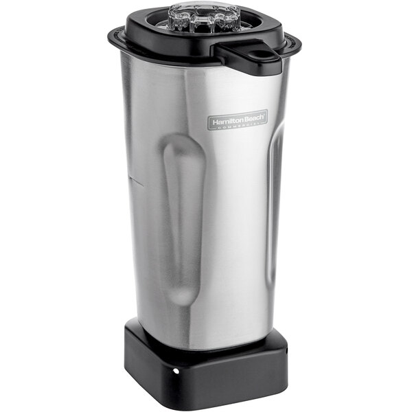 A stainless steel Hamilton Beach blender container with blade and lid.