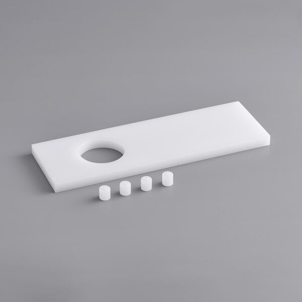 A white rectangular tray with holes and small white cylindrical bumpers.