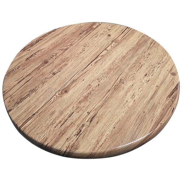 An American Tables & Seating round aged pine Isotop outdoor table top with a circular design.