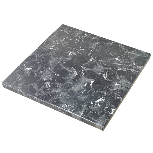 An American Tables & Seating black and white marbled Isotop tabletop on a table.