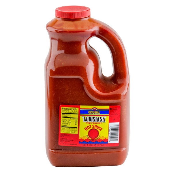 A case of four 1-gallon bottles of The Original Louisiana Brand Hot Sauce with labels.