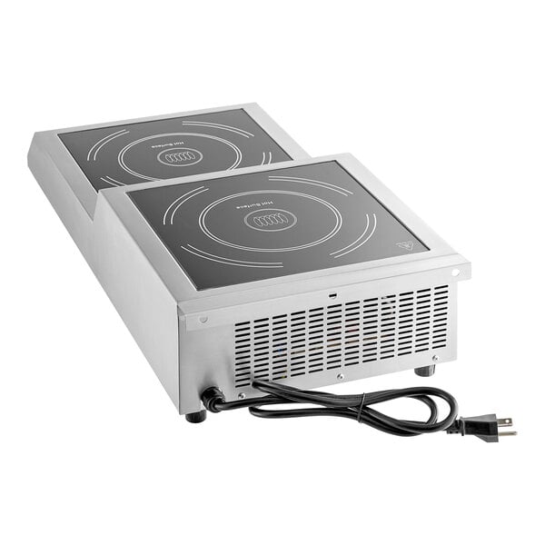 A stainless steel double countertop step-up induction range with two cooking surfaces and a power cord.