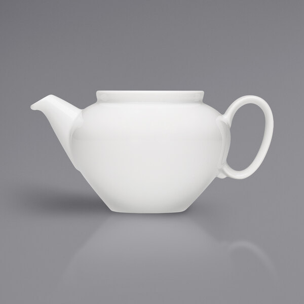 A Bauscher bright white porcelain teapot on a gray background.