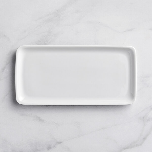 A Bauscher bright white rectangular porcelain platter on a white surface.