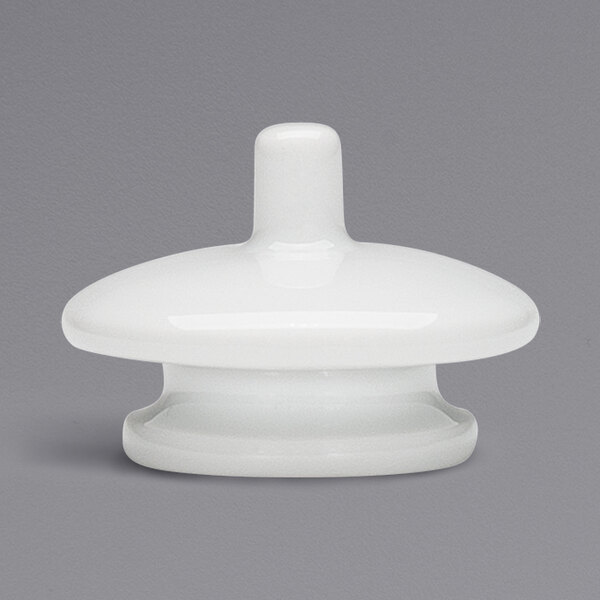 A white porcelain lid with a round knob.