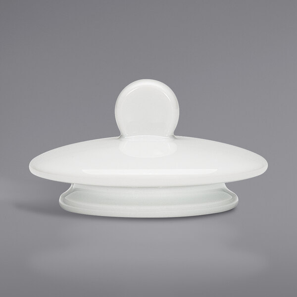 A white porcelain teapot lid with a round top.