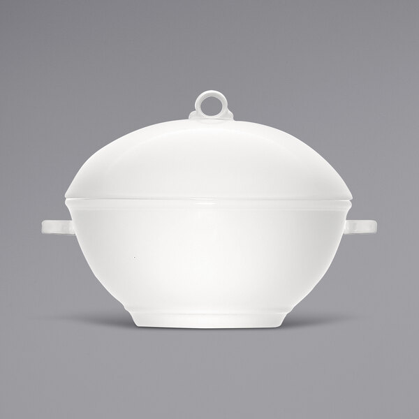 A Bauscher bright white porcelain tureen with a lid on a white surface.