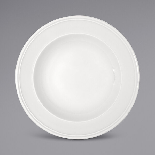 A Bauscher bright white porcelain plate with a wide rim on a white background.