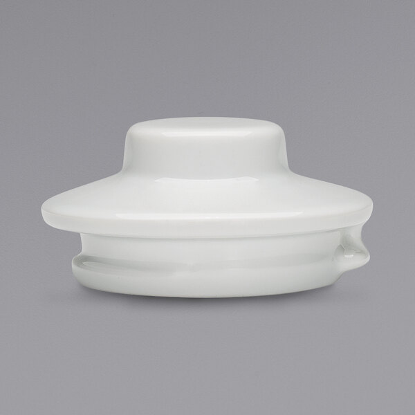 A white round porcelain teapot lid.