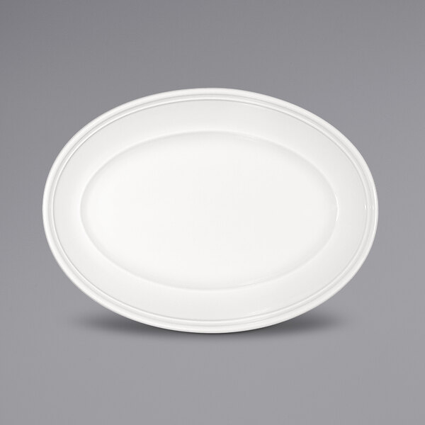 A Bauscher bright white oval porcelain platter with a wide rim.