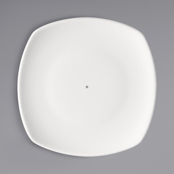 A bright white square porcelain plate with a hole in the middle.
