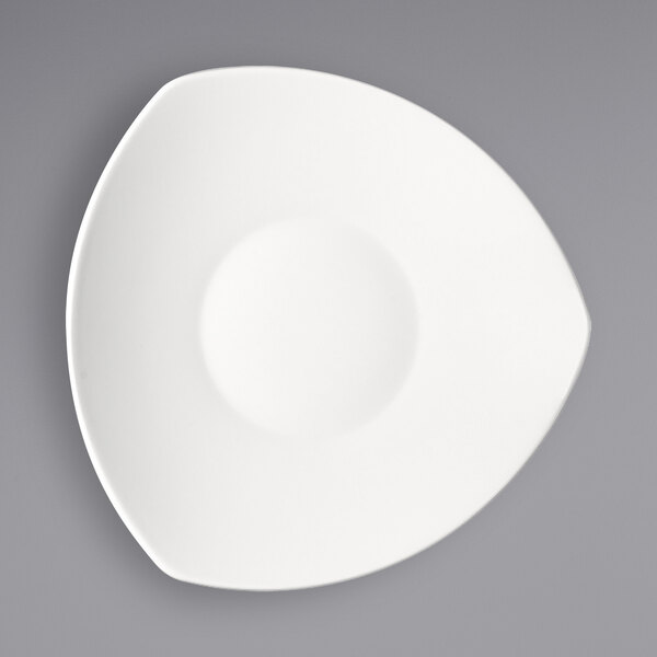 A Bauscher bright white triangular porcelain deep coupe plate with a white circle in the middle.