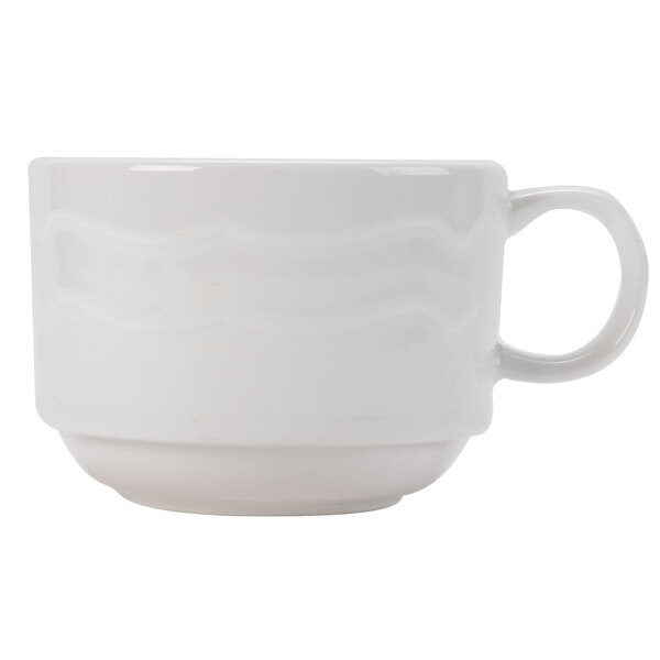 A close-up of a CAC Bone White china tea cup with a handle.