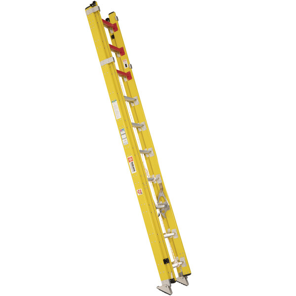 A yellow Bauer Corporation 20' fiberglass extension ladder with red handles.