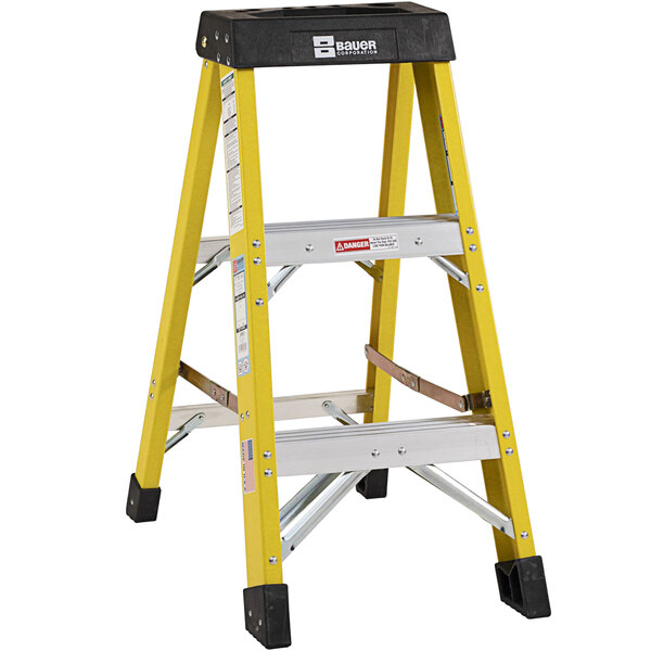 A yellow ladder with black top and black legs.