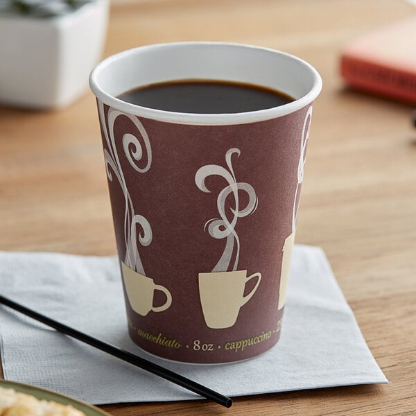 A Dart ThermoGuard paper hot cup with a design on it filled with coffee on a counter.