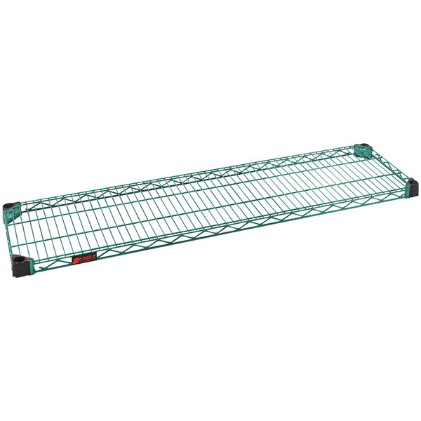 A green wire shelf with zinc wire racks on a counter.