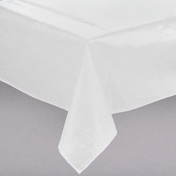 A white Intedge vinyl table cover on a table.