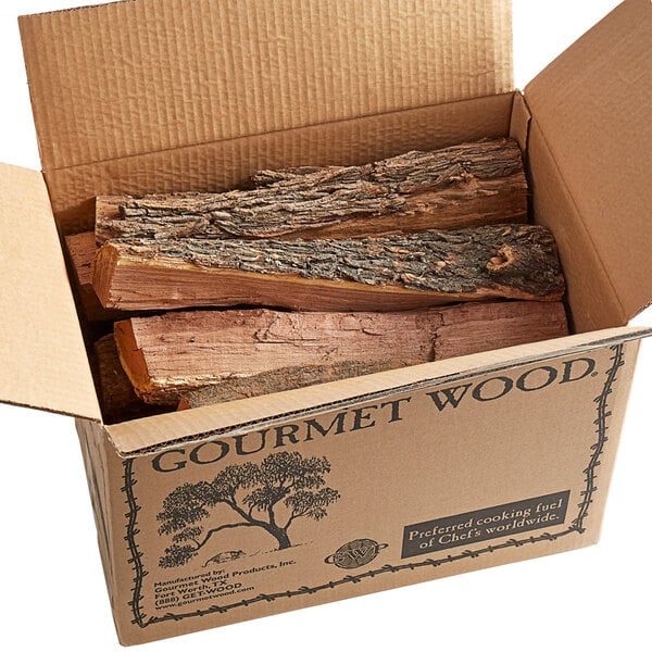 A cardboard box full of Mesquite wood logs.