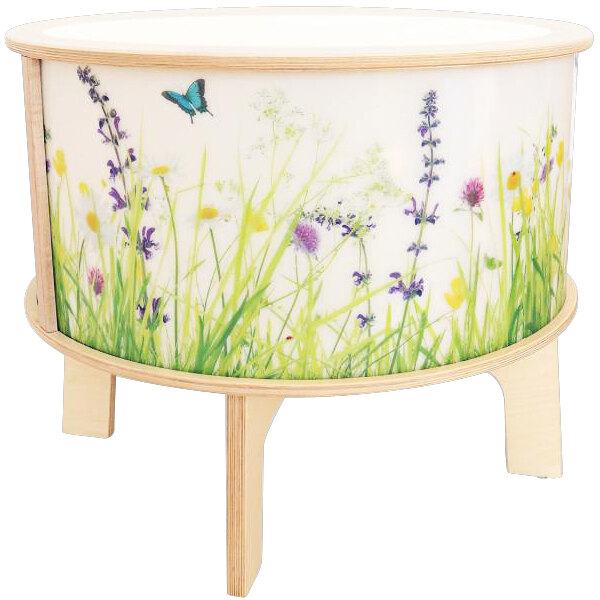 A round white Whitney Brothers Nature View LED Light Table with butterfly and grass designs on it.