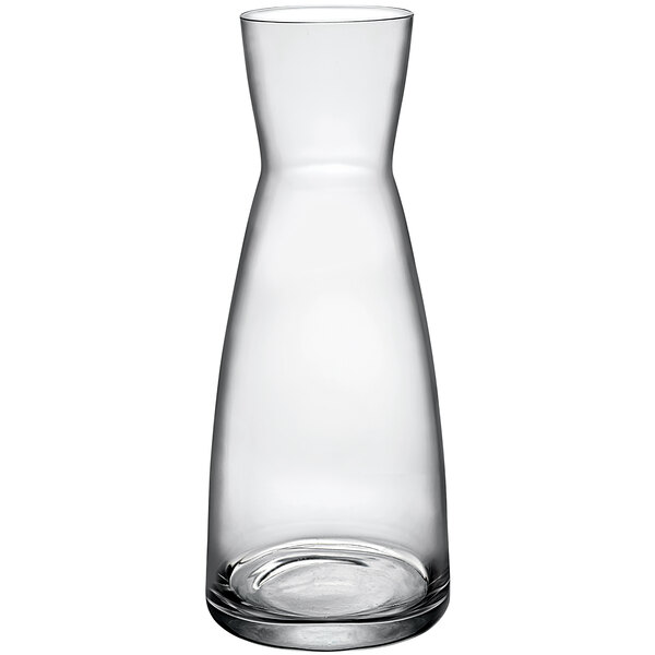 A clear glass carafe with a circular bottom.