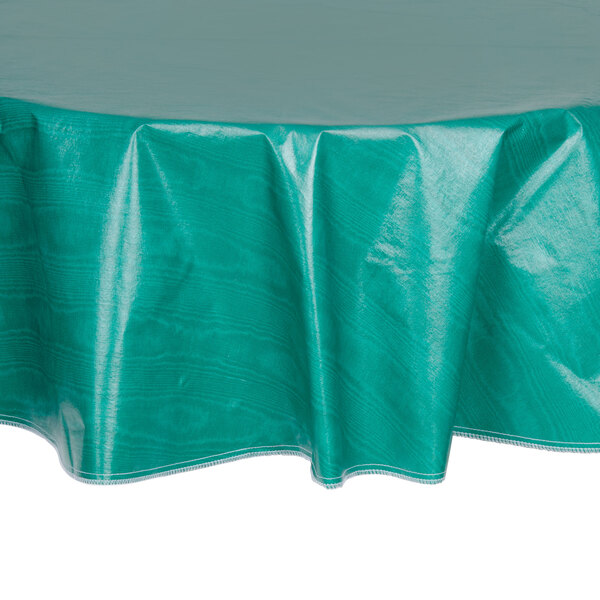A green Intedge vinyl table cover with a round top on a table.